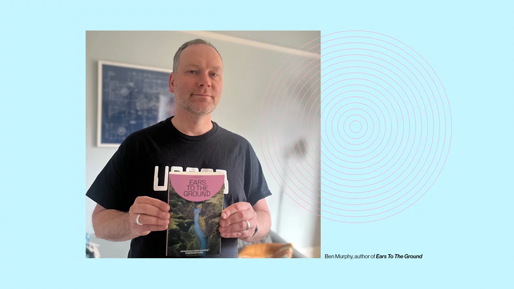 Photo of Ben Murphy holding a copy of Ears To The Ground